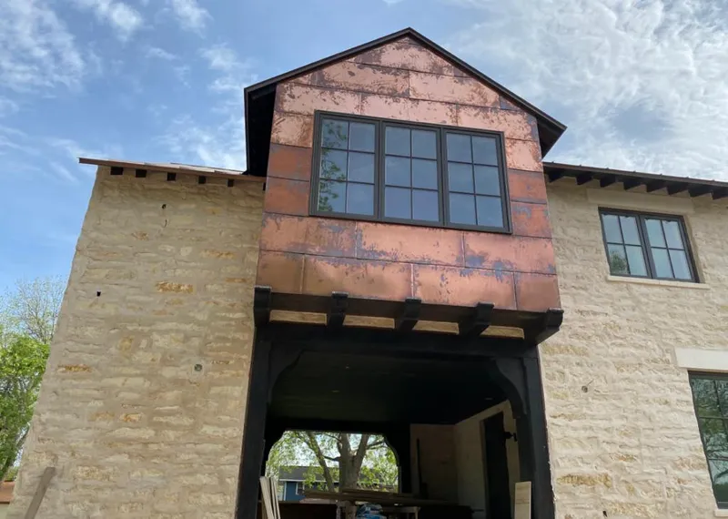Copper metal panel facade on a stone building for Metal Roof Coating in Blythewood